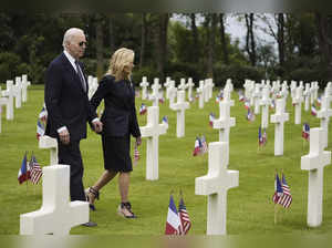 President Joe Biden and first lady Jill Biden walk in the Normandy American Ceme...