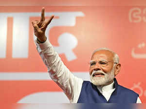 India’s Prime Minister Narendra Modi flashes victory sign at the Bharatiya Janata Party (BJP) headquarters to celebrate the party’s win in country's general election, in New Delhi on June 4, 2024.