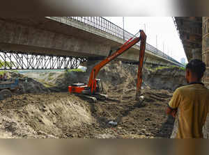New Delhi: Workers remove silt under the ITO bridge on the banks of the Yamuna r...