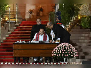 India’s Bharatiya Janata Party (BJP) leader, Jagat Prakash Nadda (C) signs after taking the oath of office as cabinet minister during the oath-taking ceremony at the presidential palace Rashtrapati Bhavan in New Delhi on June 9, 2024.