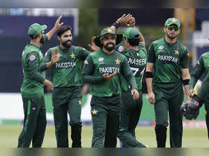 Pakistan's Mohammad Amir, second left, celebrates with teammates after the dismi...