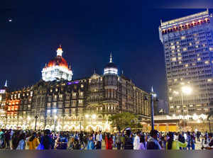 Mumbai: People outside the illuminated Taj Mahal Palace during the celebration o...