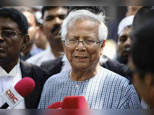 FILE- Nobel Peace Prize winner Muhammad Yunus, center, speaks to the media after...