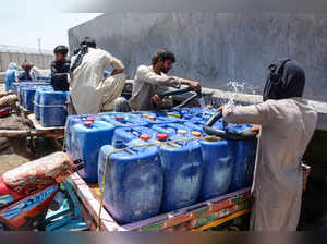 Vendors fill cans with water during a hot summer day in Jacobabad, in Pakistan's Sindh province on May 28, 2024, amid the ongoing heatwave conditions.