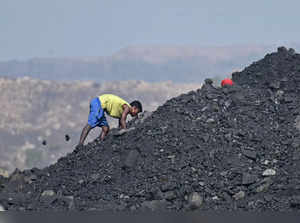 A coal picker works at an open coal mine near Jharia on the outskirts of Dhanbad in India's Jharkhand state on May 24, 2024.