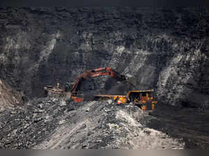 A loader loads coal in the truck at an open cast coal field at Topa coal mine in the Ramgarh district in the eastern Indian state of Jharkhand