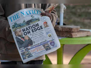 A newspaper vendor holds The Nation newspaper with a cover picture of the missing plane Vice State President Saulos Klaus Chilima in Lilongwe, on June 11, 2024.