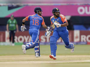 India's captain Rohit Sharma, right, and partner Virat Kohli run between wickets...