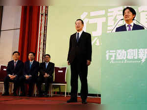 Incoming Defence Minister Wellington Koo stands next to Taiwan President-elect Lai Ching-te while he speaks during a press conference, in Taipei