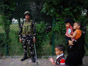Indian security personnel stands guard on street in Srinagar