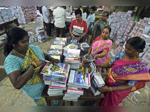 Hyderabad: Telangana Government Textbook Press employees pack books that will be...