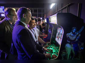 Visitors play Street Fighter on a vintage arcade cabinet machine at Morocco's Gaming Expo in Rabat on May 24, 2024.