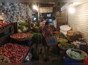 FILE PHOTO: A woman shops at a vegetable market in a residential area in Mumbai