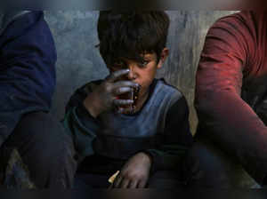 A boy sips a cup of tea during a break from work in an aluminum cookware manufacturing factory in Al-Bab, on the outskirts of Aleppo, on June 2, 2024.