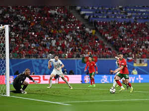 Portugal's forward #26 Francisco Conceicao (R) prepares to shoot and score his team's second goal during the UEFA Euro 2024 Group F football match between Portugal and the Czech Republic at the Leipzig Stadium in Leipzig on June 18, 2024.