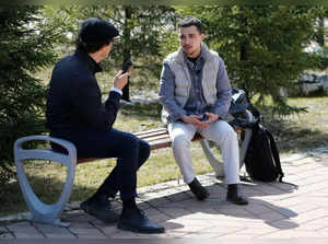 Russian army deserter Farkhad Ziganshin (R), 24, speaks during an interview with AFP in Astana on April 16, 2024.