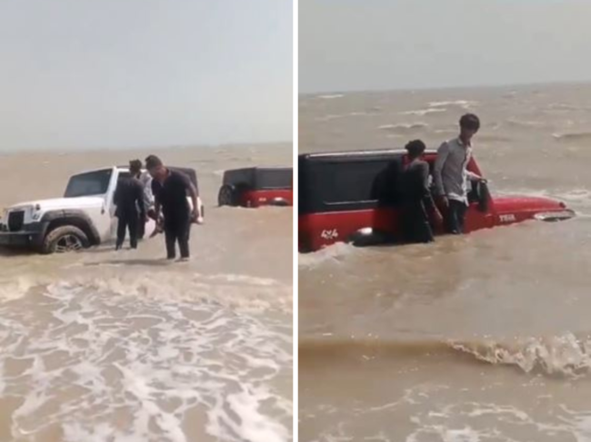College students stranded in sea with SUVs