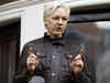 Why is Julian Assange flying to the remote Pacific island of Saipan?