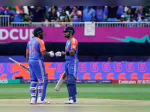 India's captain Rohit Sharma celebrates with teammate Virat Kohli after Sharma hit six during the ICC men's Twenty20 World Cup 2024 group A cricket match between India and Pakistan at Nassau County International Cricket Stadium in East Meadow, New York on June 9, 2024.