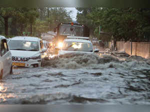 New Delhi: Vehicles wade through a waterlogged road amid rains, in New Delhi, Fr...