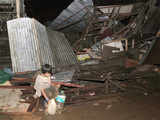 A boy fetches water from a broken pipe