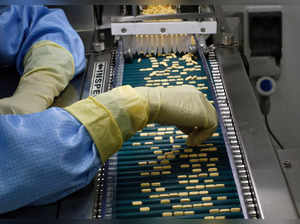 FILE PHOTO: An employee inspects tablets as they move along the production line at a pharmaceutical plant of Lupin, India's No. 2 drugmaker, in Verna