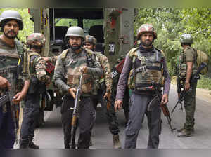Kulgam: Security personnel stand guard during an encounter with terrorists, in K...