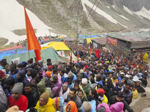 Anantnag: Devotees stand in queue outside the Amarnath Temple to offer prayers d...
