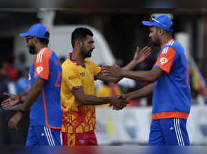 Zimbabwe captain Sikandar Raza, center, shakes hands with Indian players at the ...