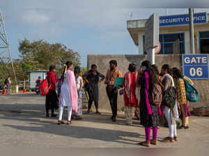 FILE PHOTO: Job aspirants talk with a hiring agent outside the Foxconn plant in Sriperumbudur