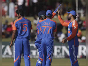 India cricketers celebrate a wicket during the third T20 match between Zimbabwe ...