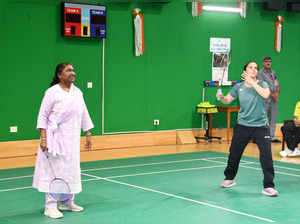 New Delhi, Jul 10 (ANI): President Droupadi Murmu plays badminton with ace shutt...
