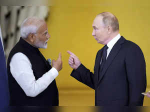 Russian President Vladimir Putin, right, and Indian Prime Minister Narendra Modi...