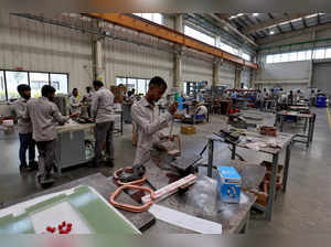 FILE PHOTO: Employees assemble an electric transformer inside a manufacturing unit of Electrotherm (India)  Private Limited at Sanand GIDC (Gujarat Industrial Development Corporation), on the outskirts of Ahmedabad