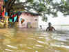 Two men, in flood-ravaged Lakhimpur Kheri, walk home with their sister's body
