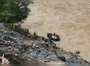 Search for dozens missing after landslide sweeps buses into Nepal river is suspended