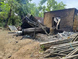 Dhalai: Charred remains of a house after communal clashes broke out following th...