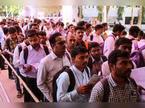 Job seekers line up for interviews at a job fair in Chinchwad
