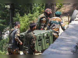 Doda: Army personnel carry weapons and equipment near the encounter site, in Des...
