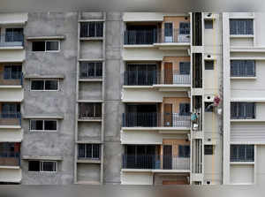 FILE PHOTO: Workers paint the exteriors of a newly constructed residential building on the outskirts of Kolkata