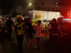 Israelis gather at the site of an explosion amid the Israel-Hamas conflict in Tel-Aviv