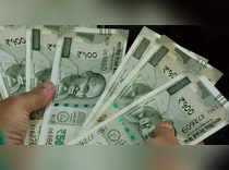 Rupee hits record low against dollar on corporate demand; closes at 83.662
