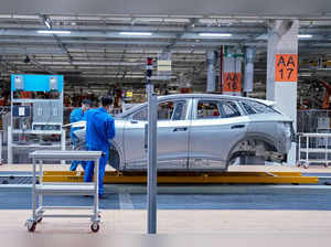 Employees work on assembly line during a construction completion event of SAIC Volkswagen MEB electric vehicle plant in Shanghai