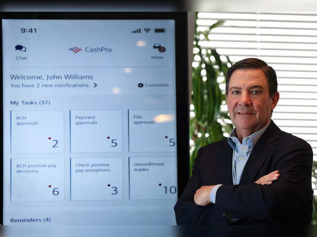 Mark Monaco, head of Enterprise Payments at Bank of America, poses with a display of BofA’s CashPro app during an interview with Reuters in New York