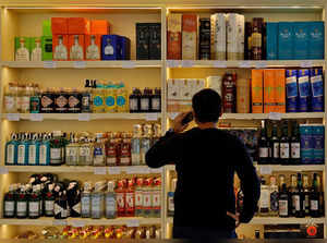FILE PHOTO: A customer looks at liquor bottles for purchase at a liquor store in Gurugram
