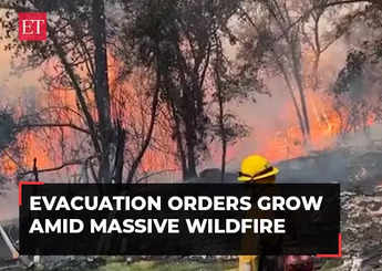 US: California wildfire sparked by a burning car triples in size in a day