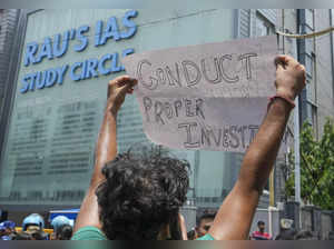 New Delhi: A student holds a poster during a protest outside Rau’s IAS Study Cir...