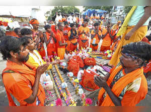 Prayagraj: Kanwariyas worship before the start of their Kanwar Yatra during Shra...