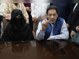 Pakistan's former Prime Minister Imran Khan, right, and Bushra Bibi, his wife