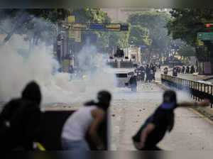 Protesters clash with police during demonstrations against the official election...